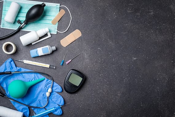 Overhead shot of medical equipment on dark stone background